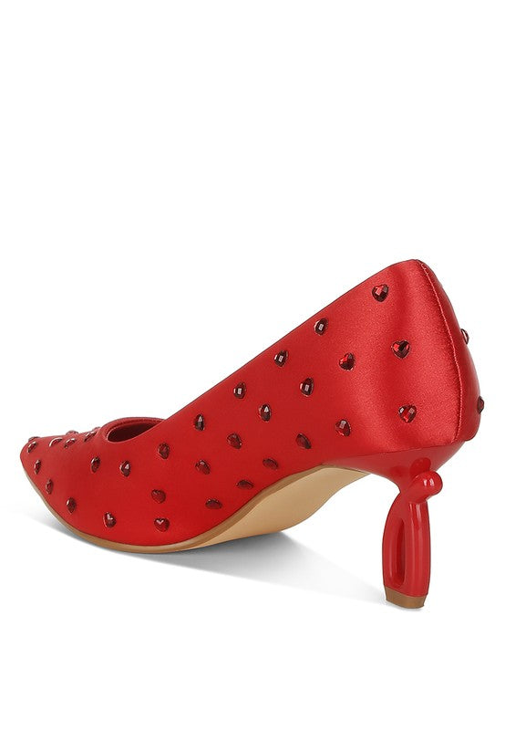 Side view of red heart-rhinestone pointed-toe pumps with decorative heel