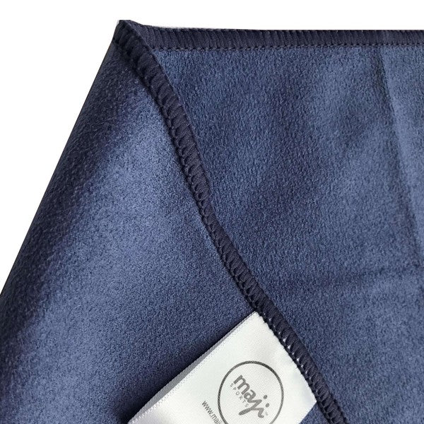 Blue hand towel corner detail with stitched border and small brand tag