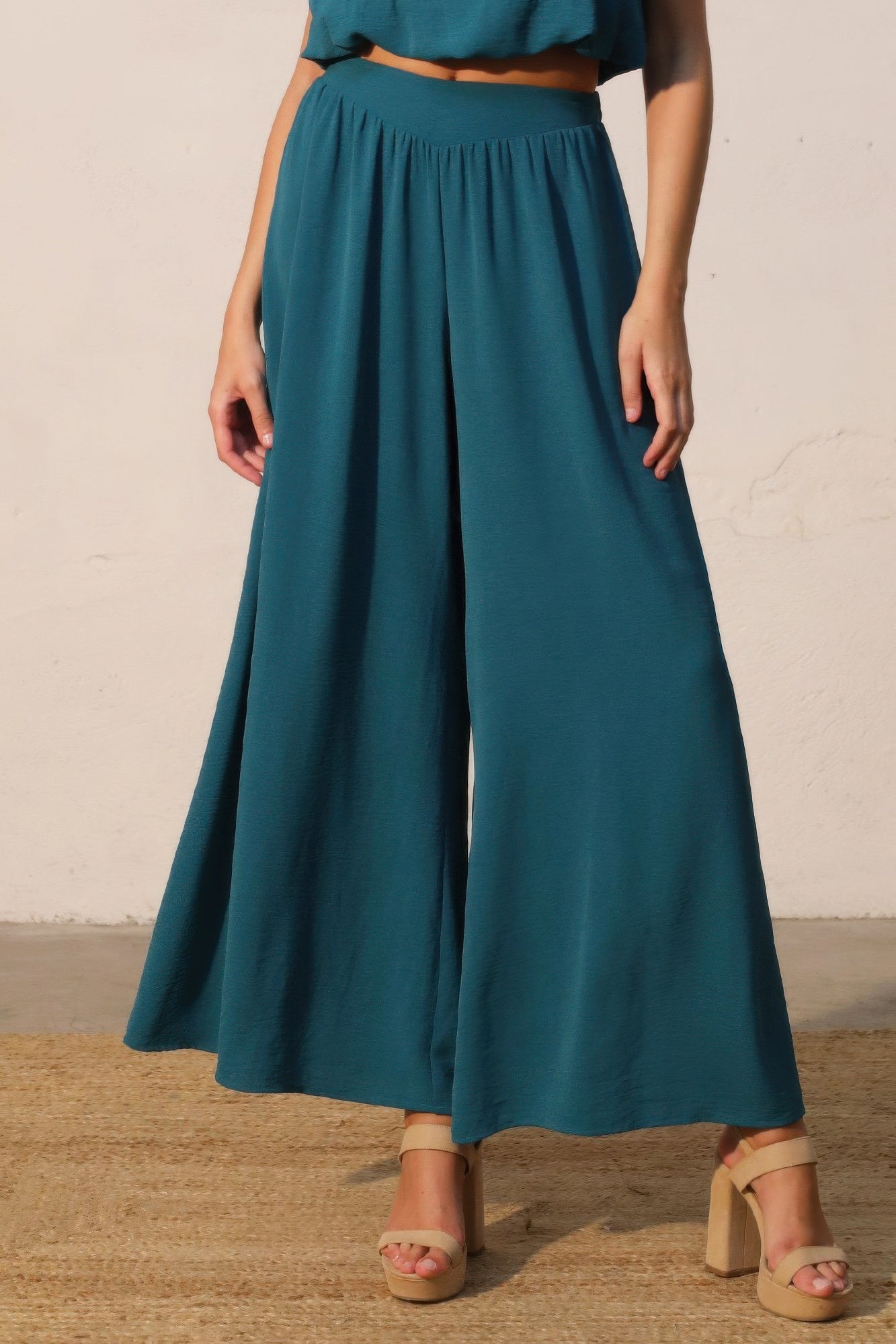 Teal wide-leg swing pants with gathered elastic waist and full-length flare
