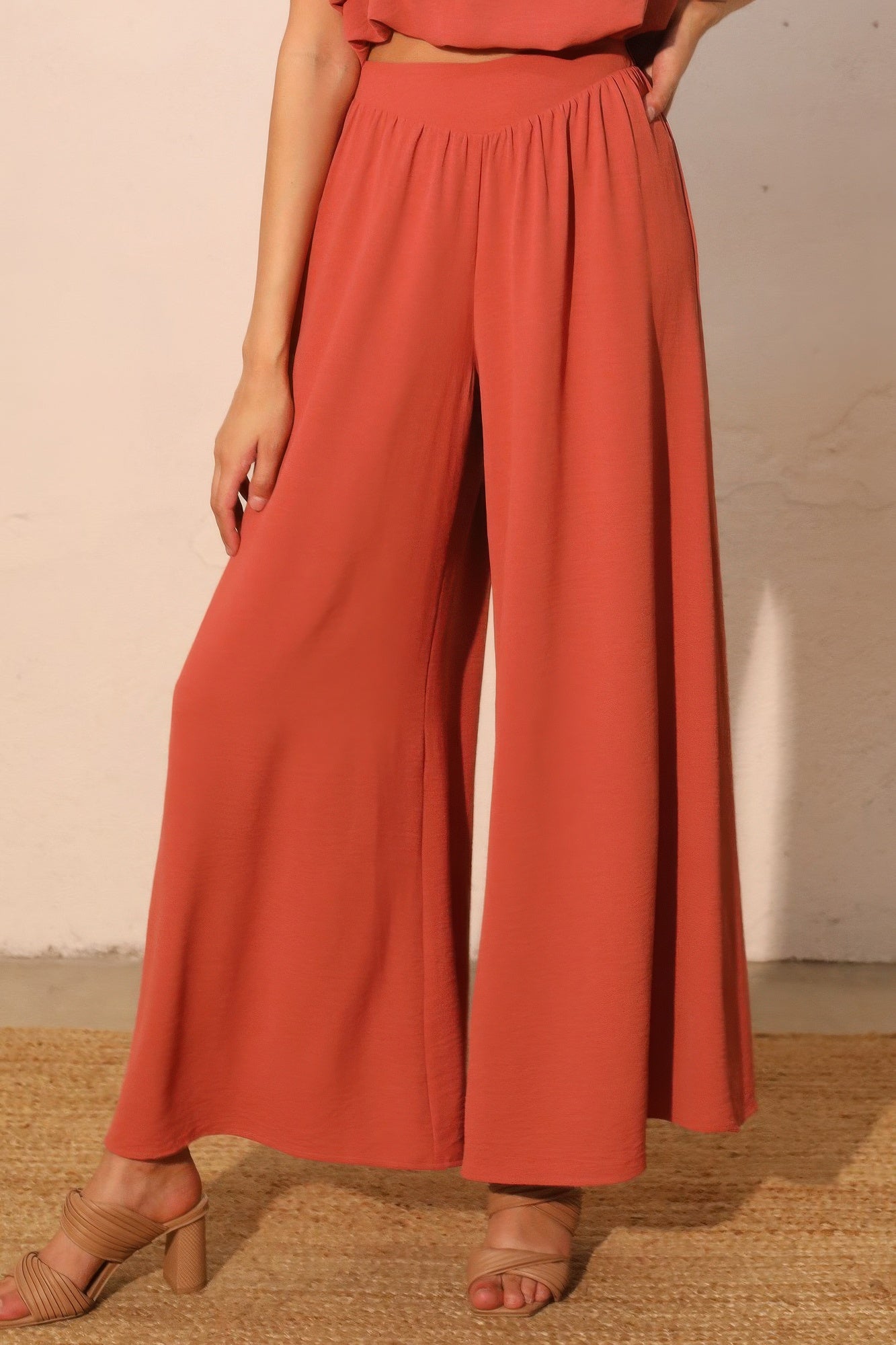 Rust wide-leg swing pants with elastic waist and gathered front pleats
