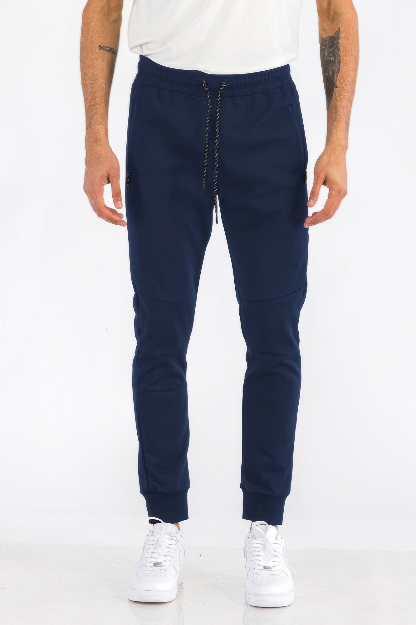 Mens solid jogger in navy, centered front with drawstring and zip pocket detail