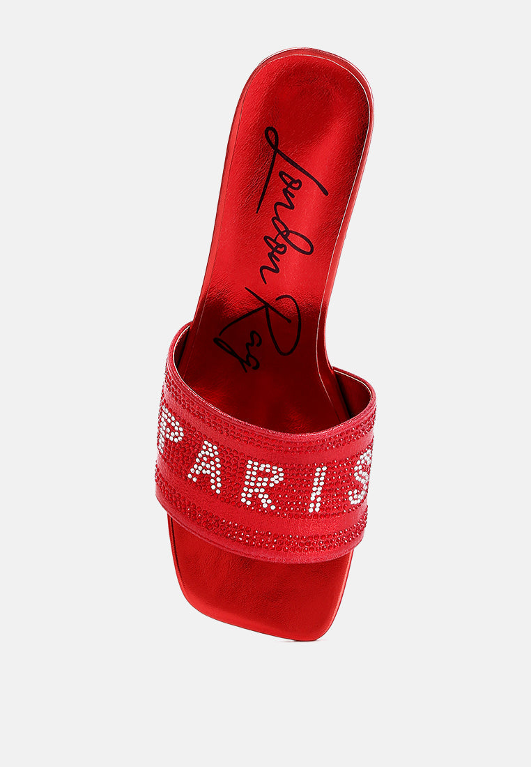 Red slide sandals showing glittery rhinestone band and open square toe