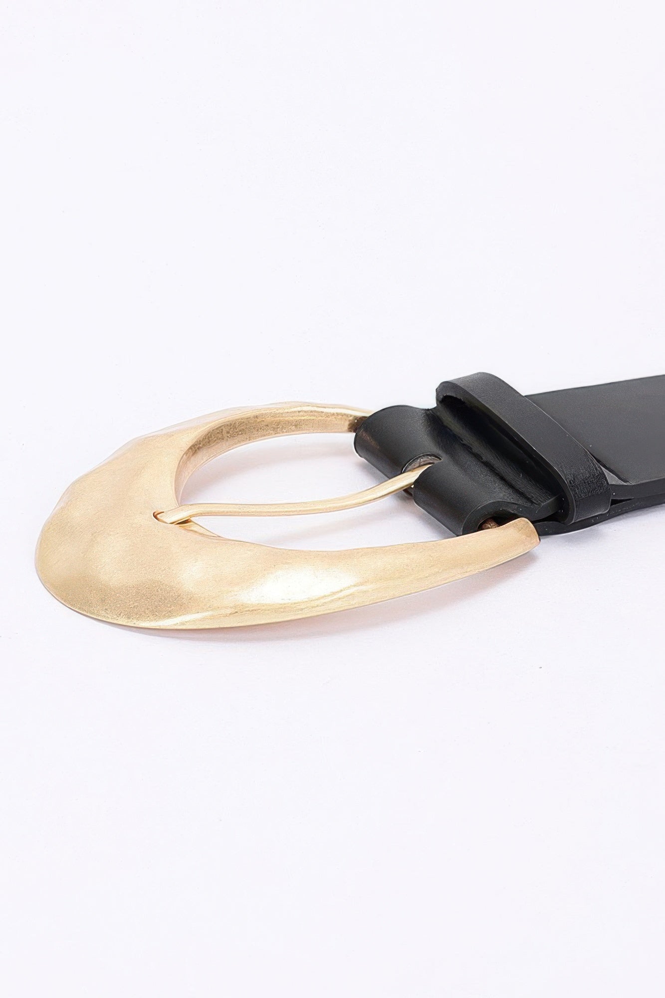 Black PU belt with gold-toned metal oval buckle, close-up of buckle loop
