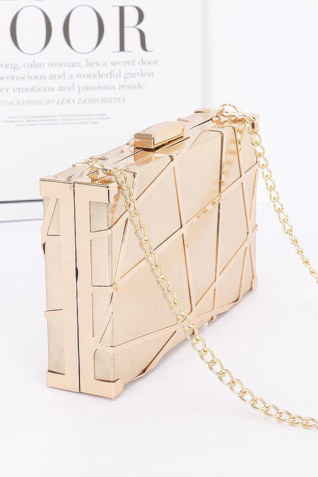 Gold metallic clutch with geometric panels and gold-tone chain shoulder strap