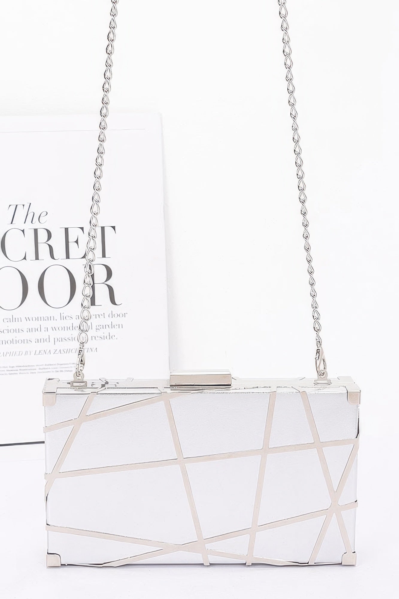 Silver metallic case clutch with chain shoulder strap and geometric frame