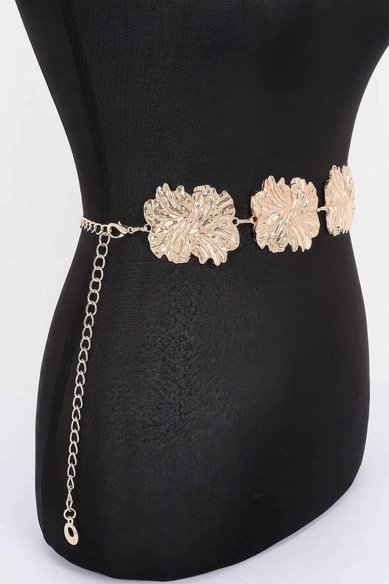 Gold metal chain belt with large flower medallions and dangling chain end
