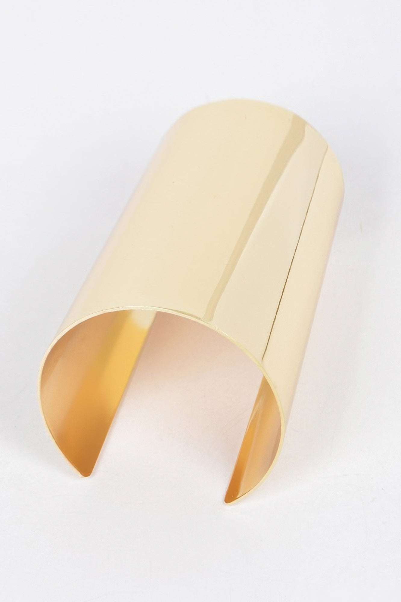 Gold cuff bracelet with curved open oval opening and polished finish