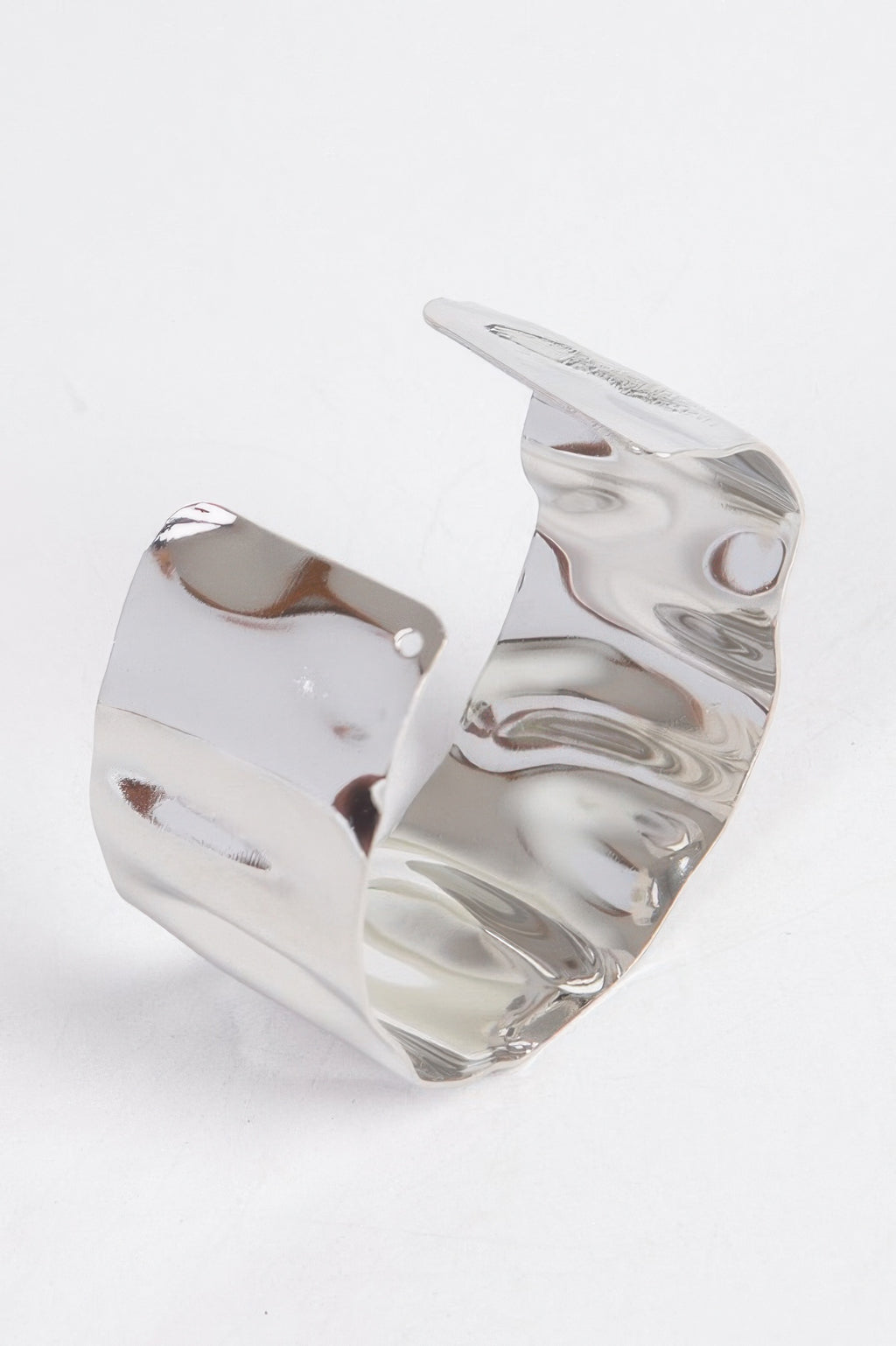 Silver metal cuff with curved top, open back and small side rivet