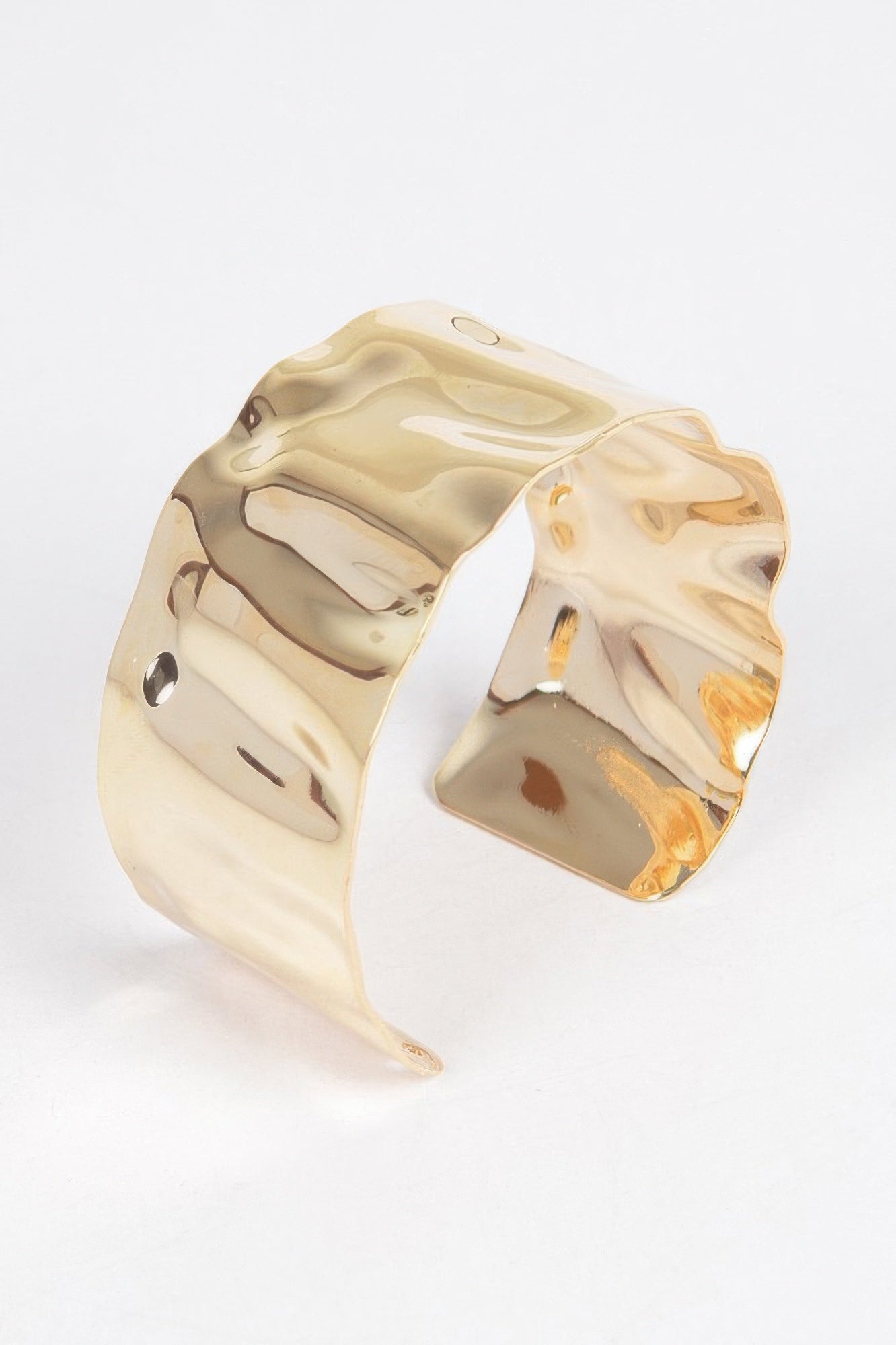 Metal cuff bracelet in gold tone, wide hinged band with open ends
