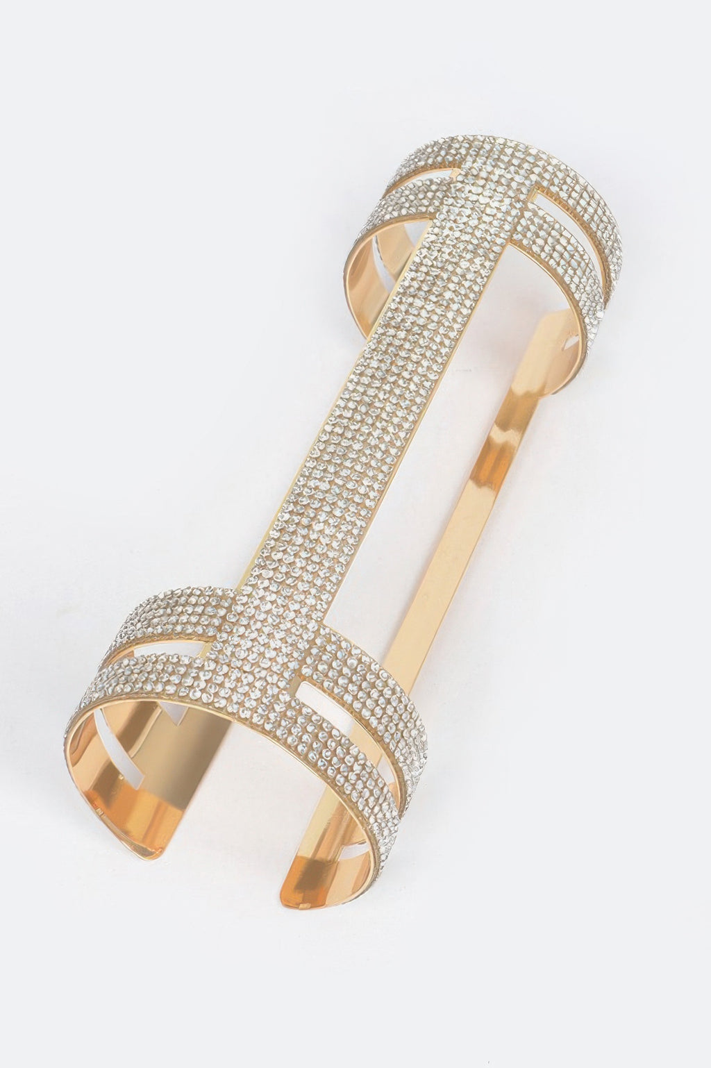 Silver rhinestone cuff with wide openwork design and flat hinged metal back