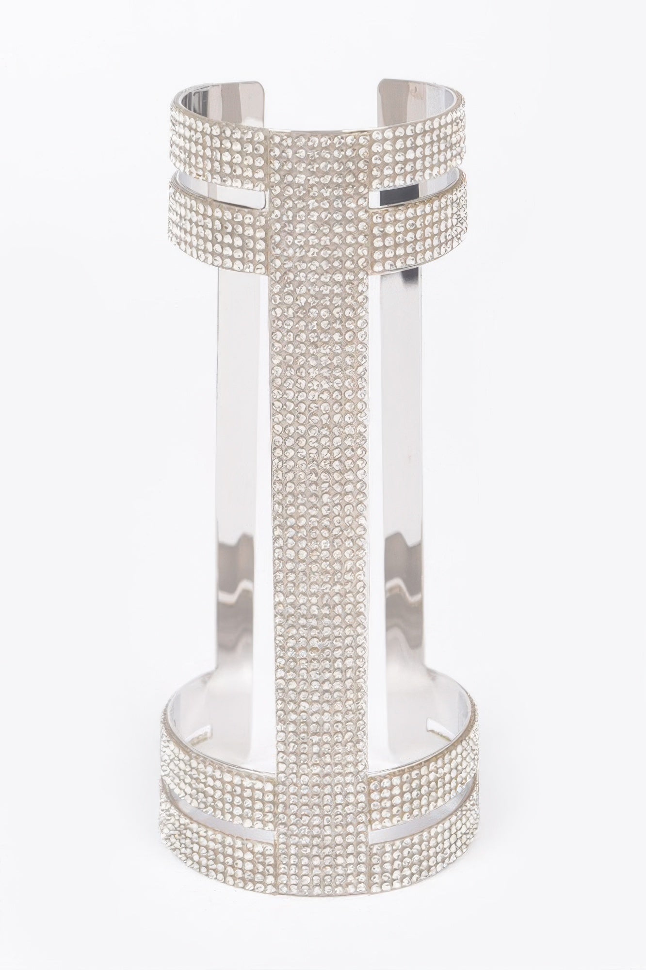 Silver crystal metal cuff with perforated cross-style panel and rounded bottom band