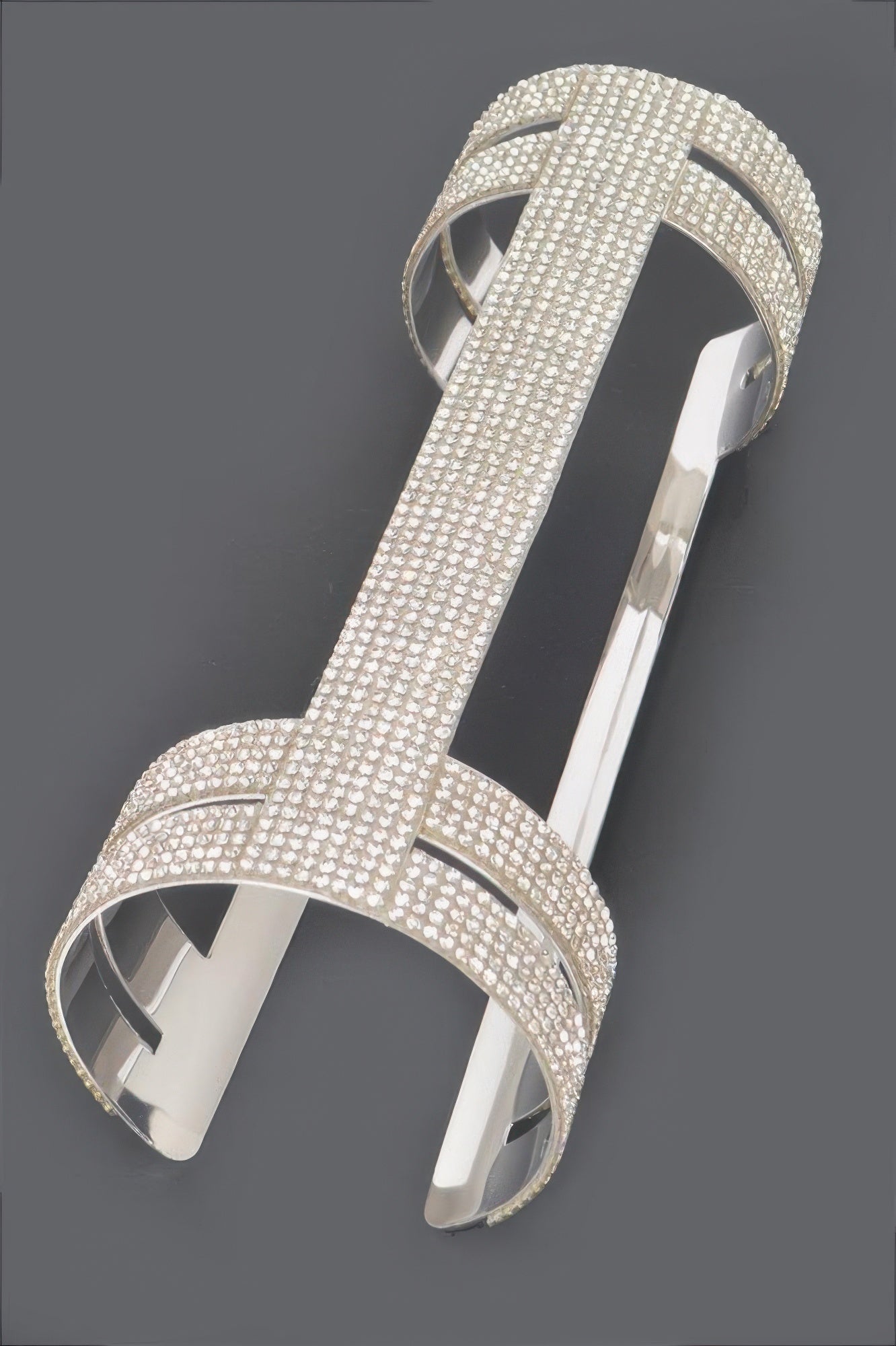 Silver rhinestone cuff with open crisscross center and curved open side straps