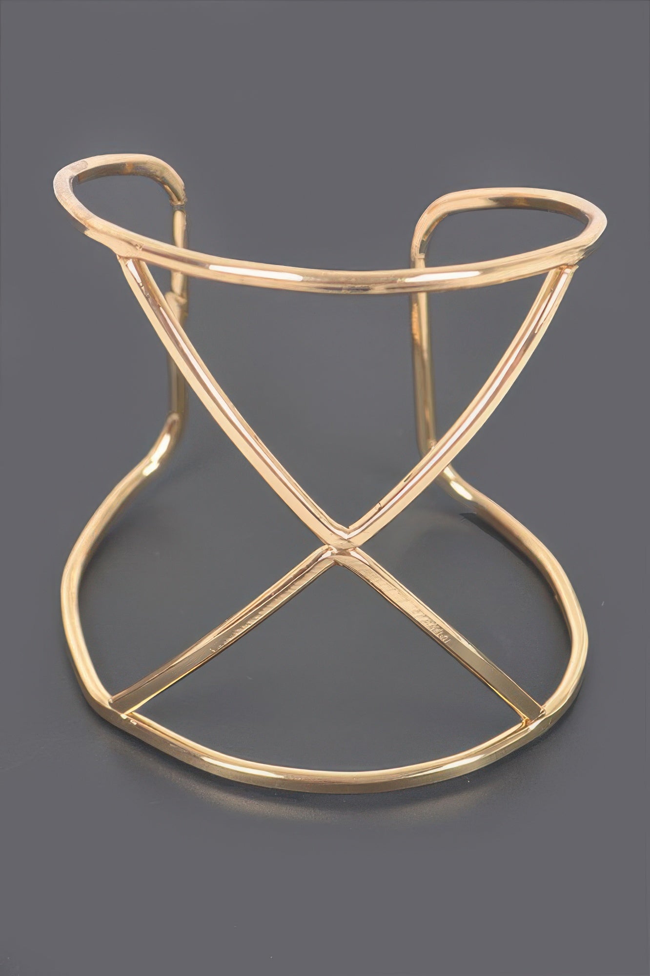 Gold Metal Cuff with open X-cross design, curved top and bottom hoops