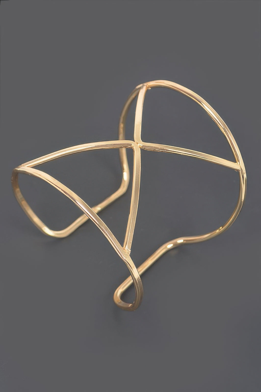 Gold cuff bracelet, open geometric frame with curved ends and diagonal bars