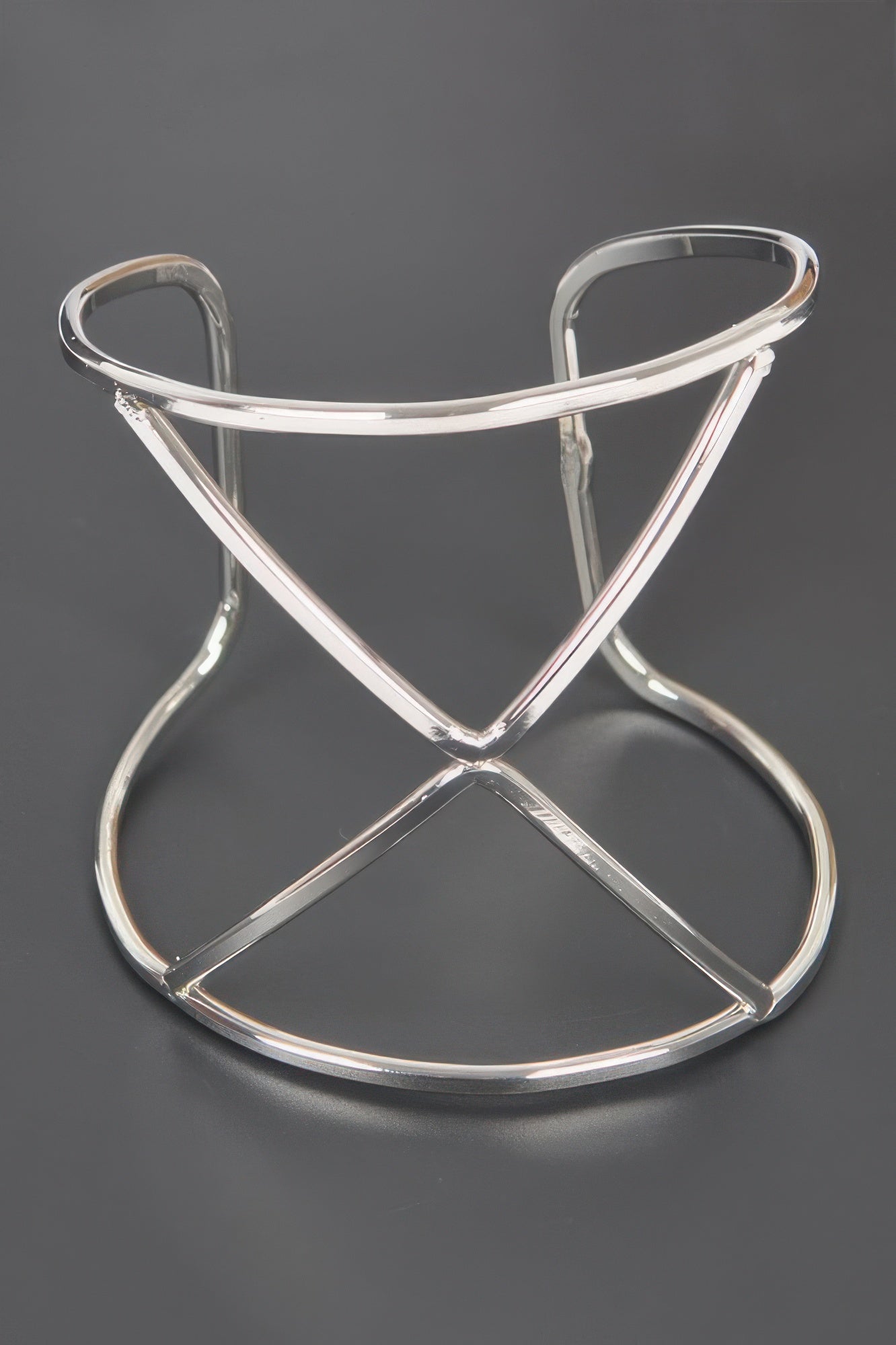 Silver metal cuff with open X-cross pattern and smooth curved hoops