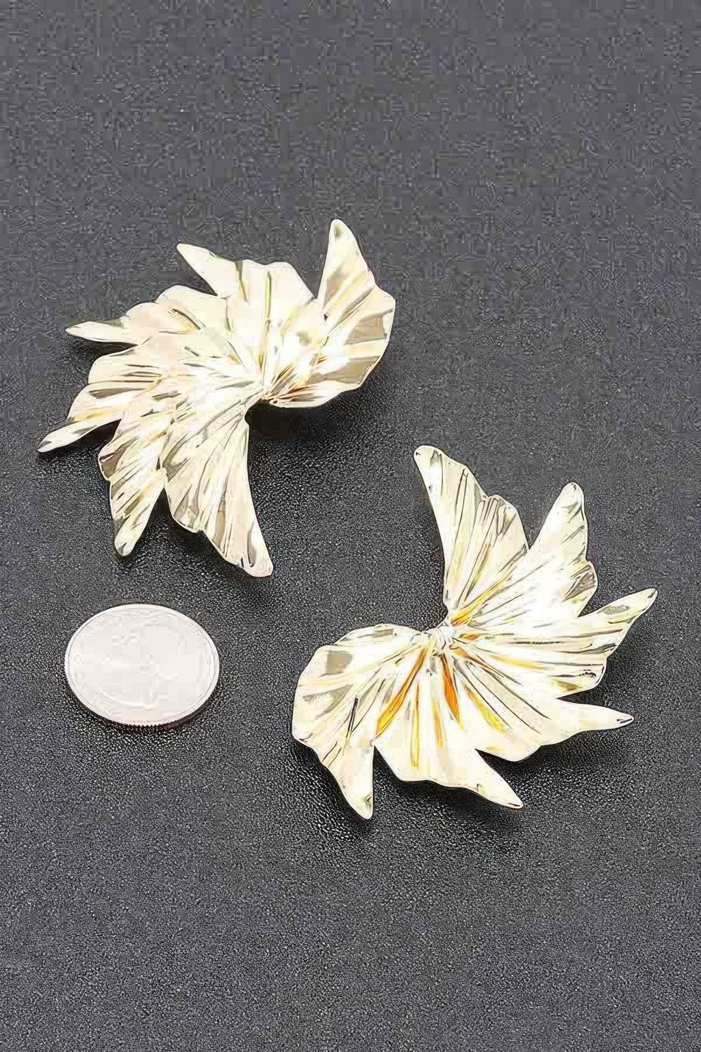 Gold-tone floral metal earrings with ridged petal design and round backing