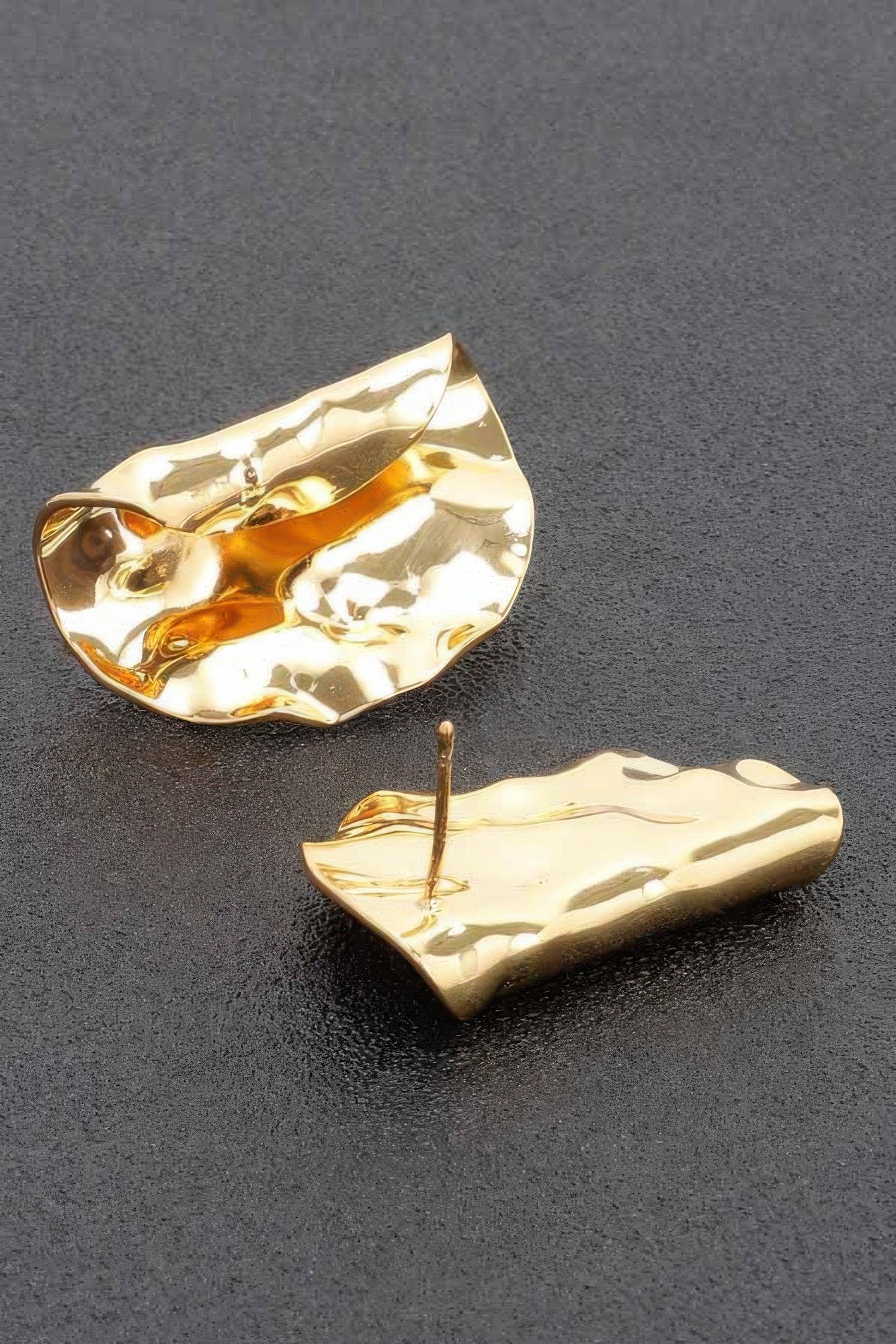 Gold dip metal earrings, angled hammered teardrop design with shiny reflective finish