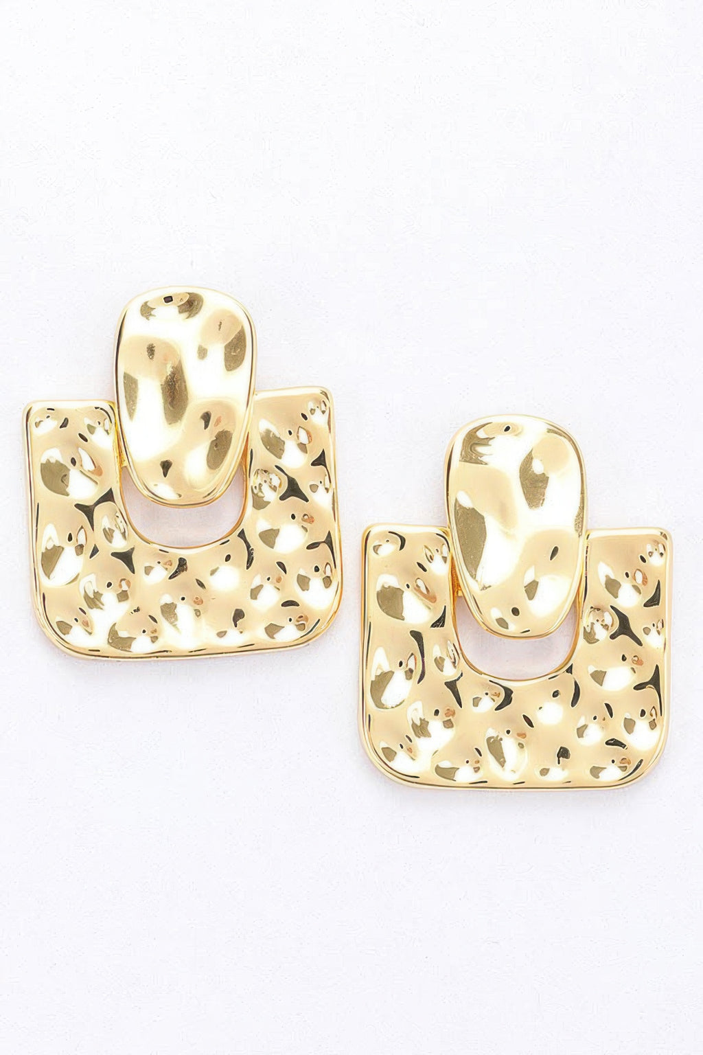 Gold dip hoop-style earrings with speckled U-shaped design and stud backs