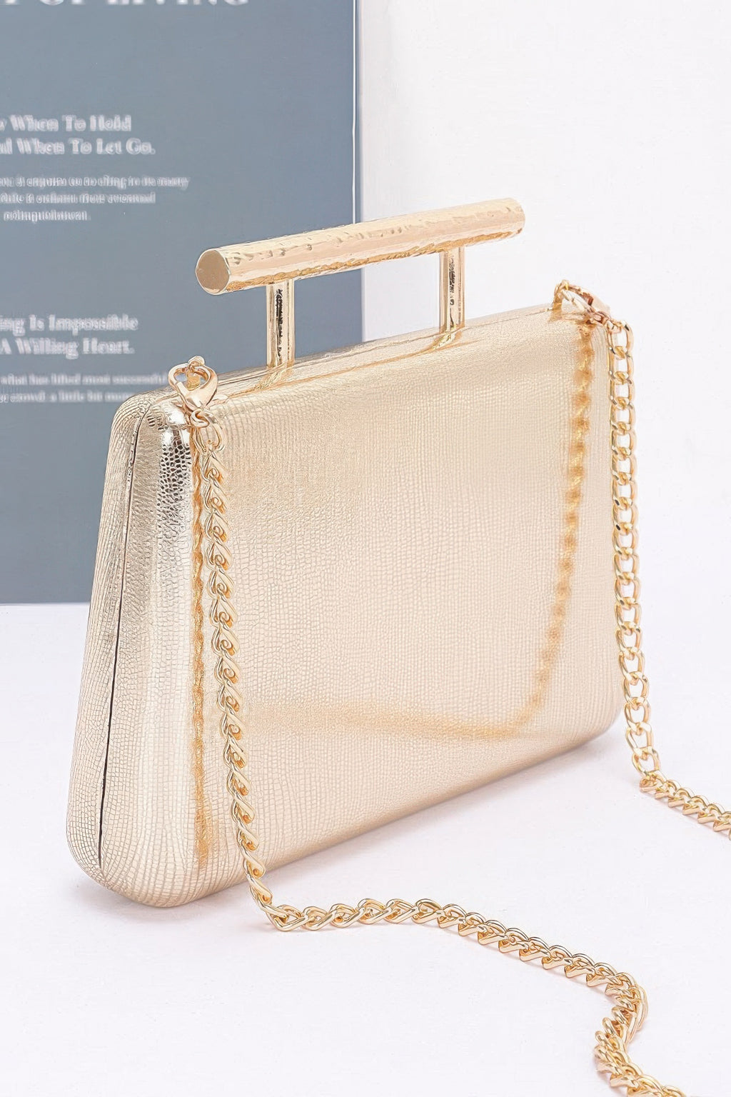 Gold-toned metal handle top case clutch with long chain shoulder strap