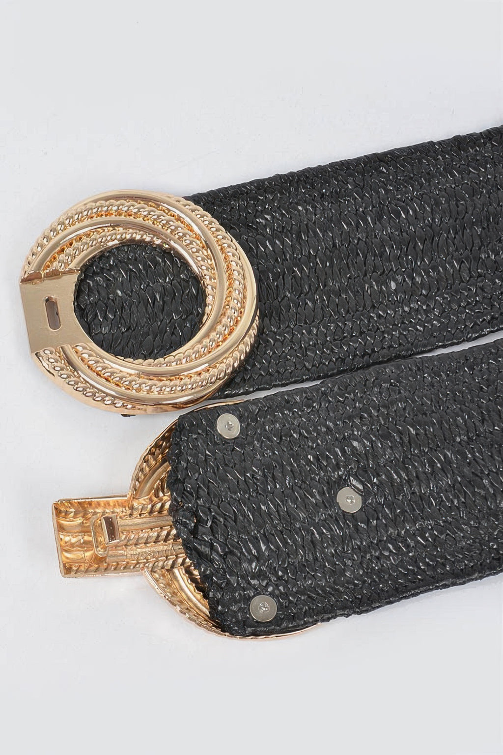 Close-up: black textured stretch straw belt with gold-tone metal buckle hardware