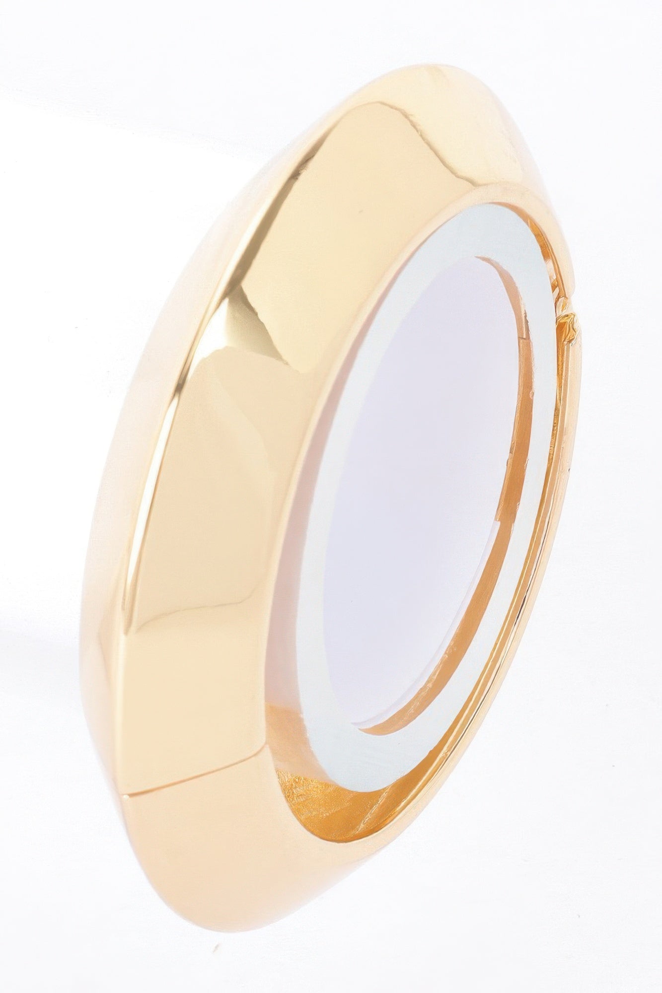 Gold metal spring hinge bracelet side view with open interior and glossy finish.