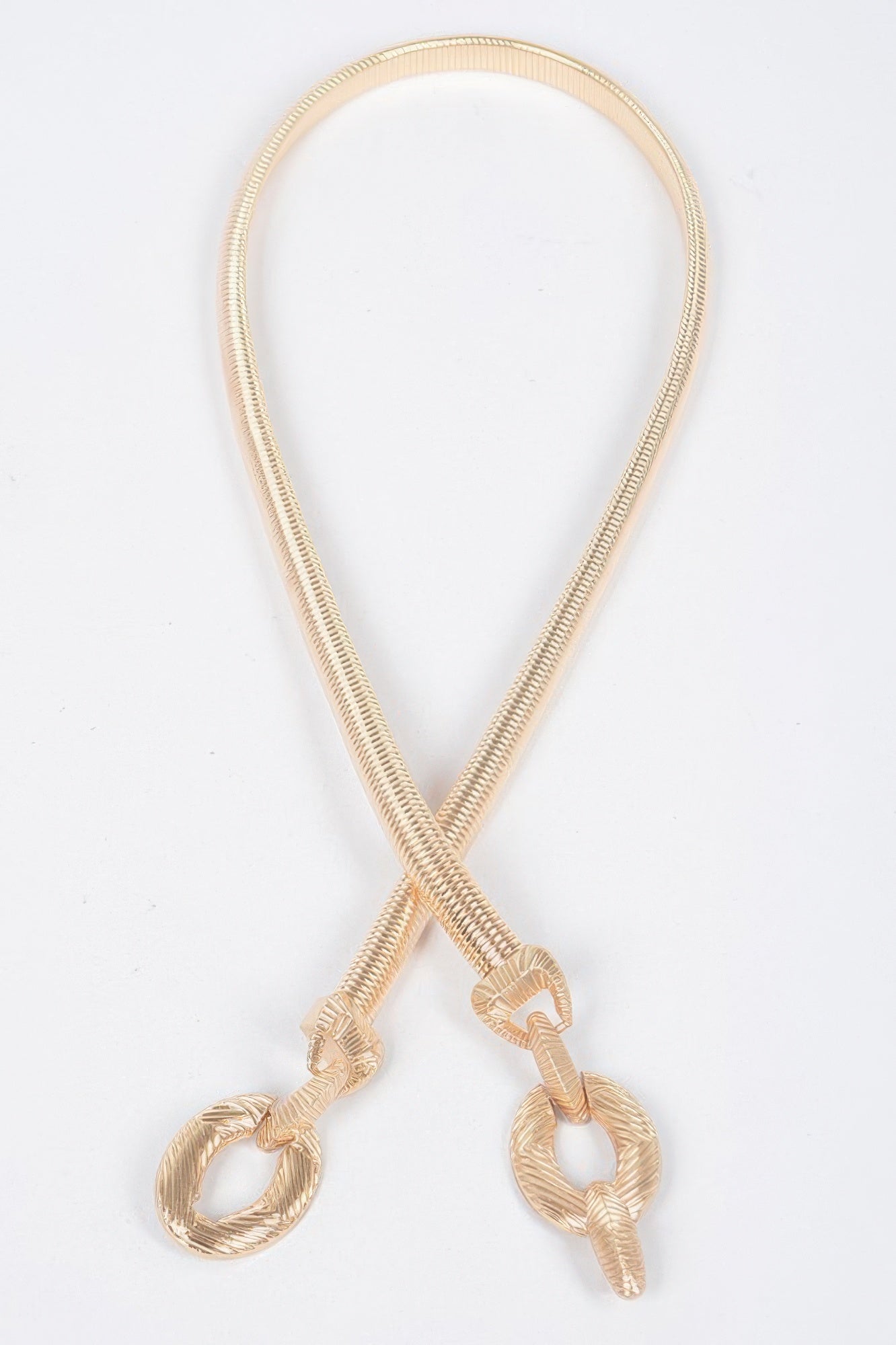 Metal stretch belt with teardrop loop and gold-tone oval links