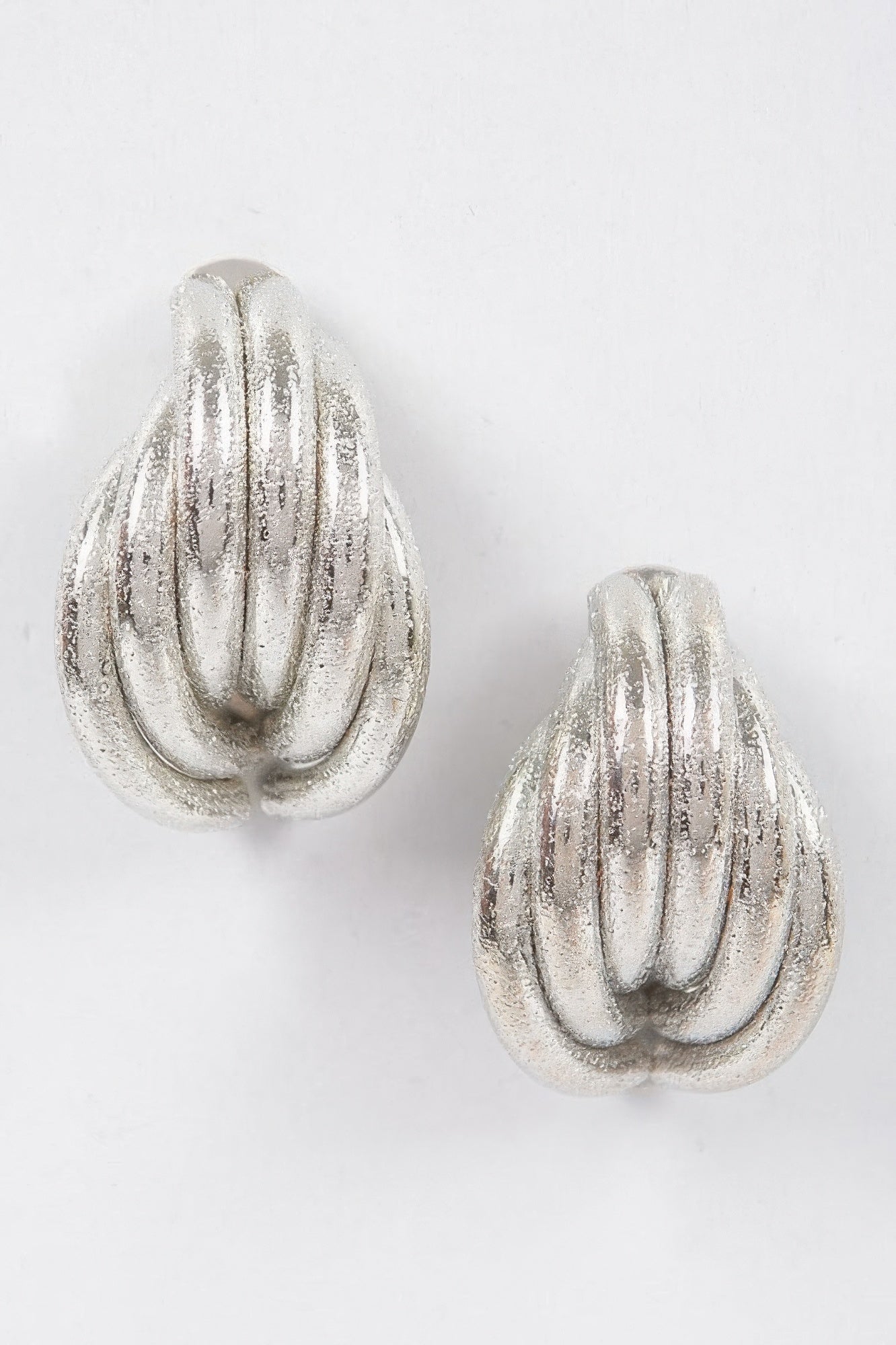Silver metal stud earrings, teardrop with ridged swirl pattern