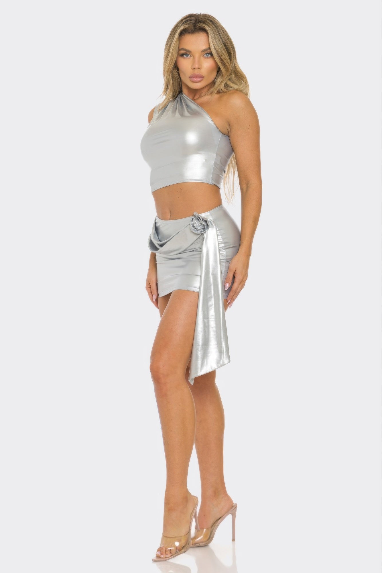 Silver one-shoulder crop top and draped wrap mini skirt, side sash and tie