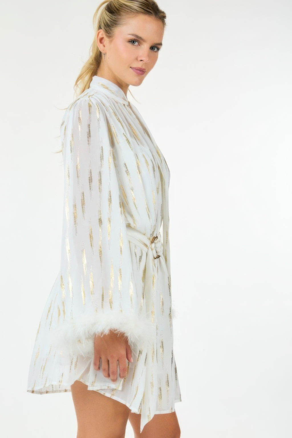 White metallic print short dress, side view; long sleeves and feathered cuff hem