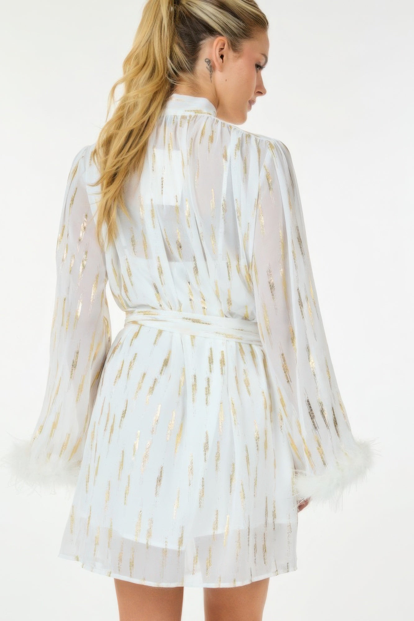 Back view: white metallic print short dress with belted waist and flared sleeves