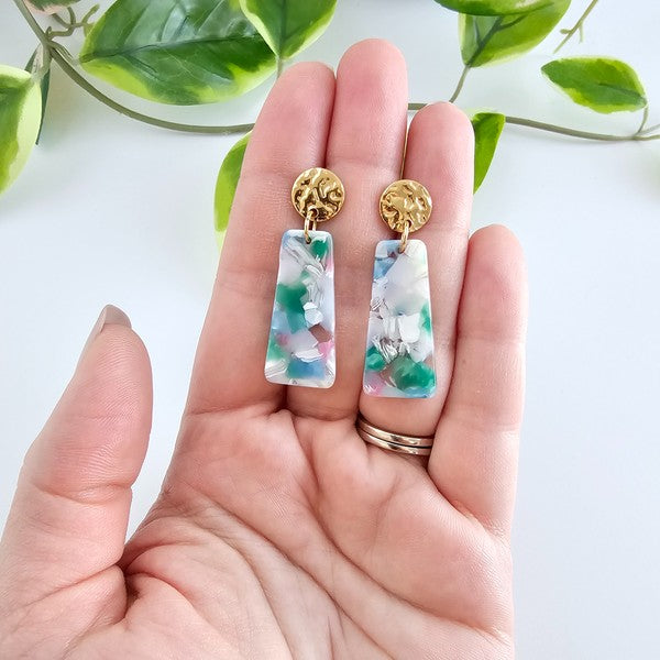 Gold round earring tops with blue-green acrylic rectangle dangles (in hand)