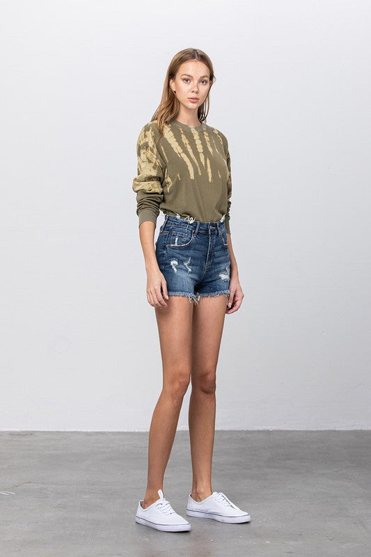 Mid rise dark wash distressed denim shorts with ripped details and belt loops