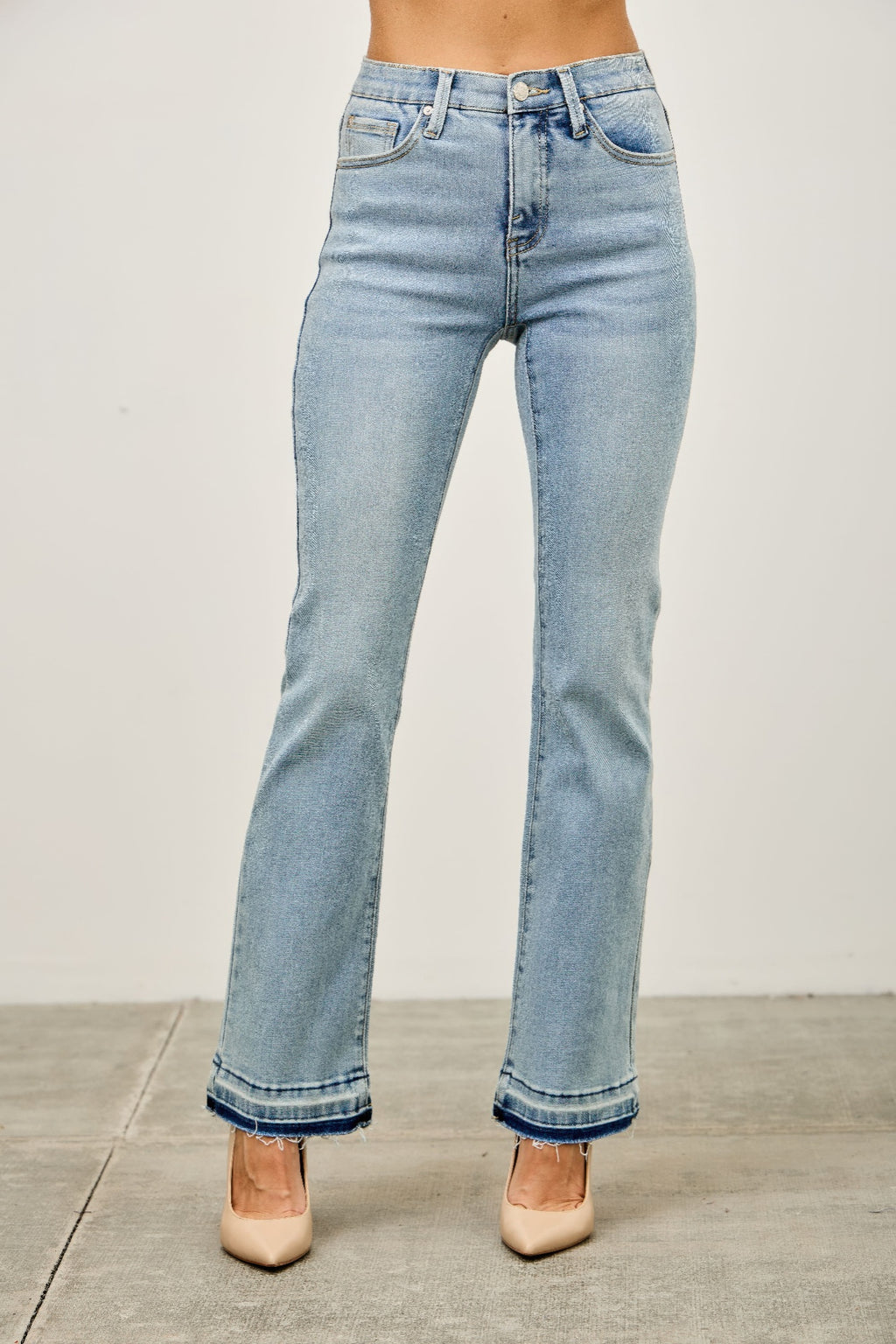 Mid-rise flare jeans with released hem, light blue wash, button and zip front