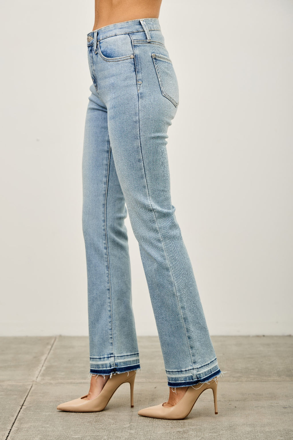 Side view mid-rise flare jeans with released hem, light blue wash and back yoke