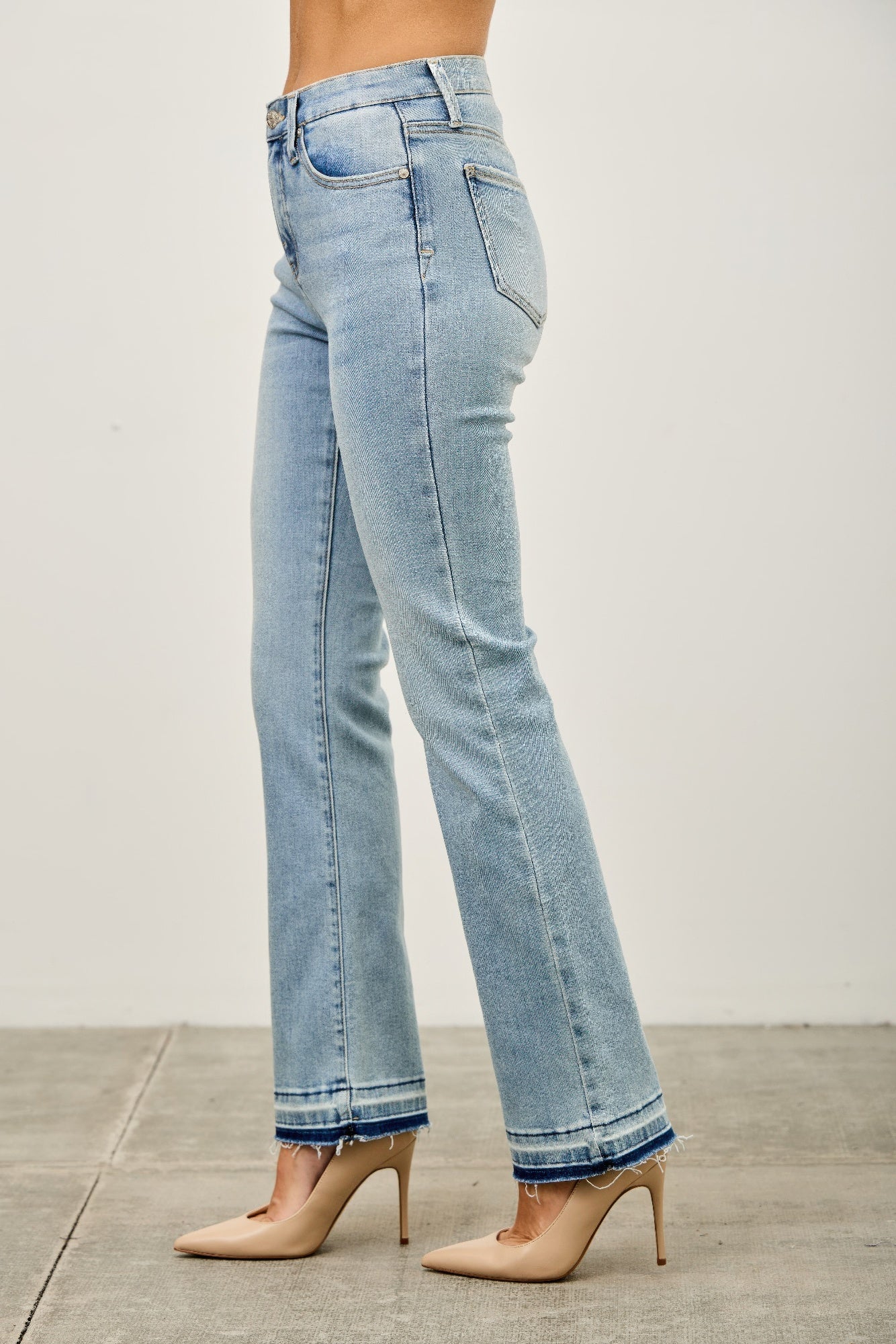 Side view mid-rise flare jeans with released hem, light blue wash and back yoke