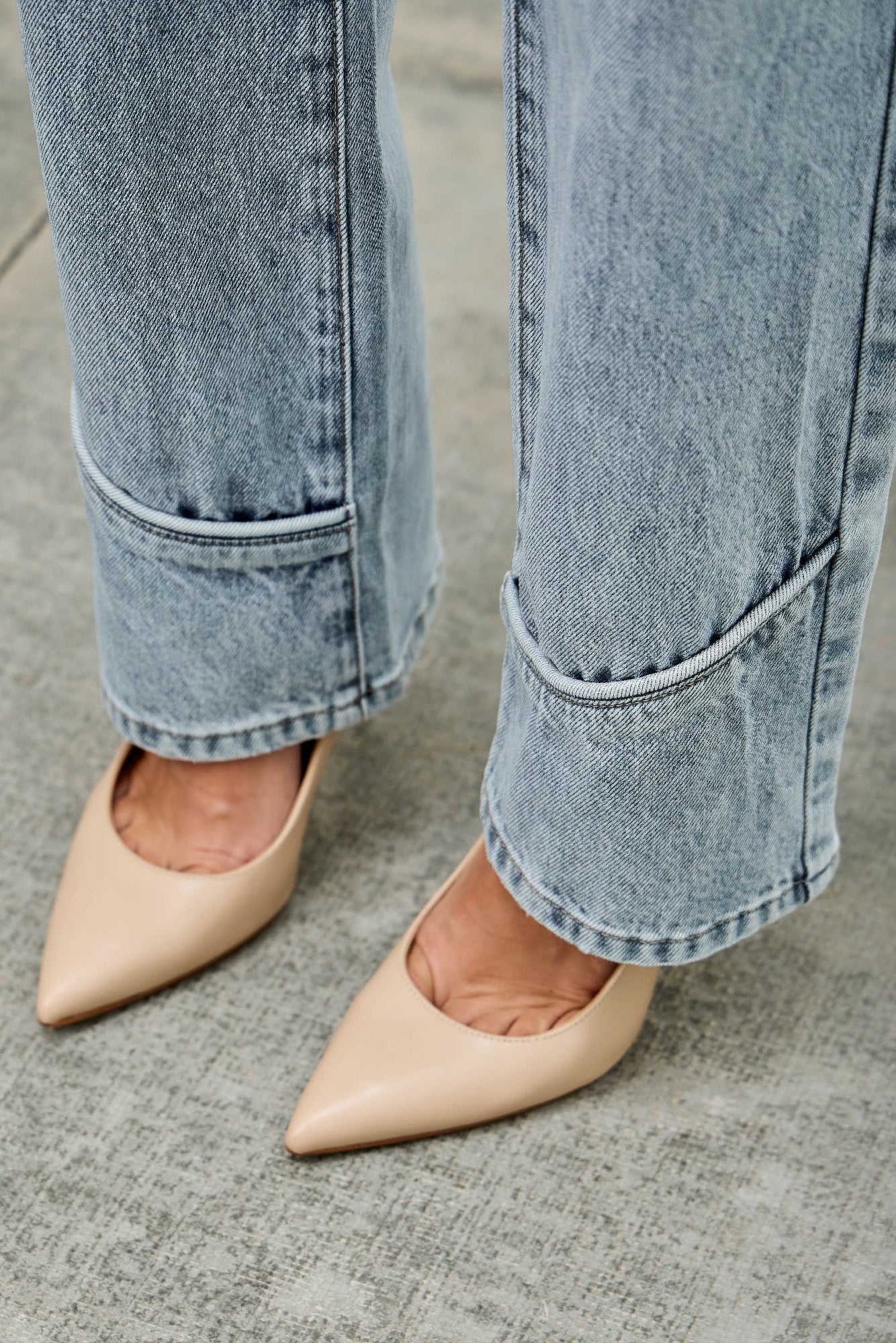 Mid-rise straight jeans with piping, cuffed hem, light-wash denim ankle view