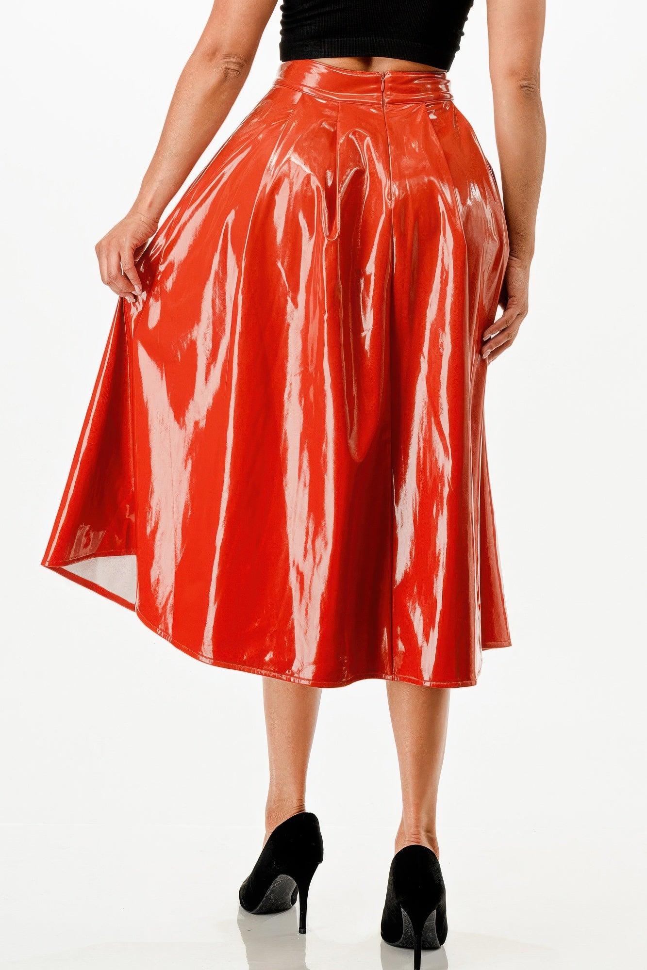 Close-up: glossy red midi skirt with pleated waistband
