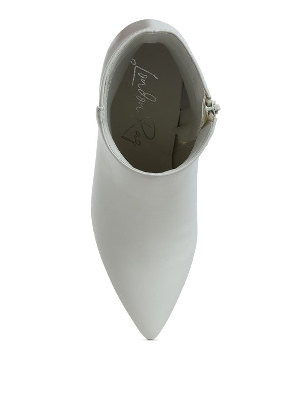 White faux leather ankle boots, inside view with side hardware/strap detail