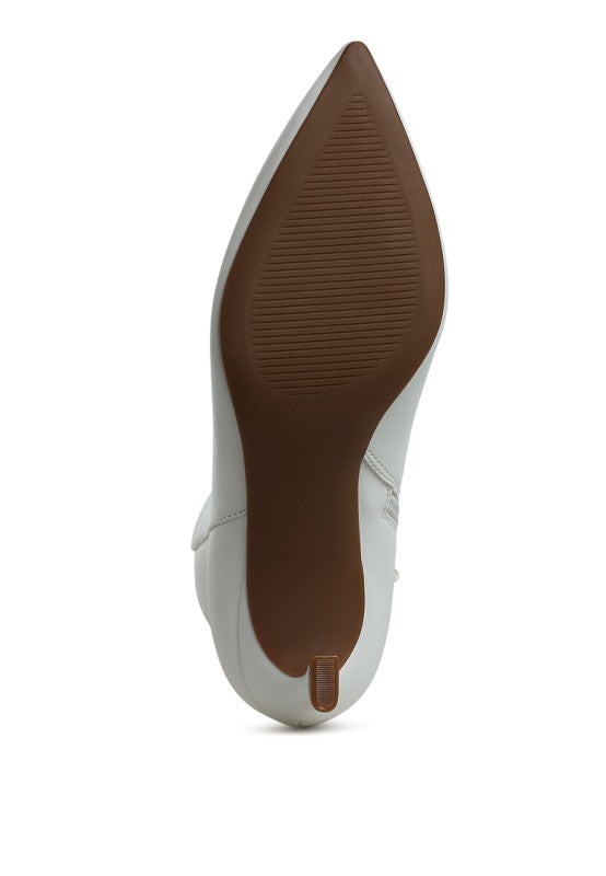 White faux leather ankle boots, heel and outsole side view with pointed toe