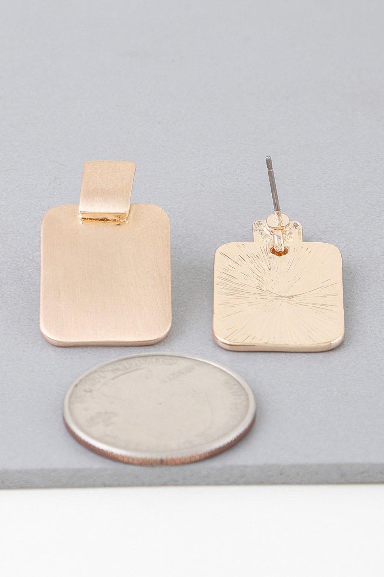 Gold geometric drop earrings with square top and sunburst-etched front panel, pair