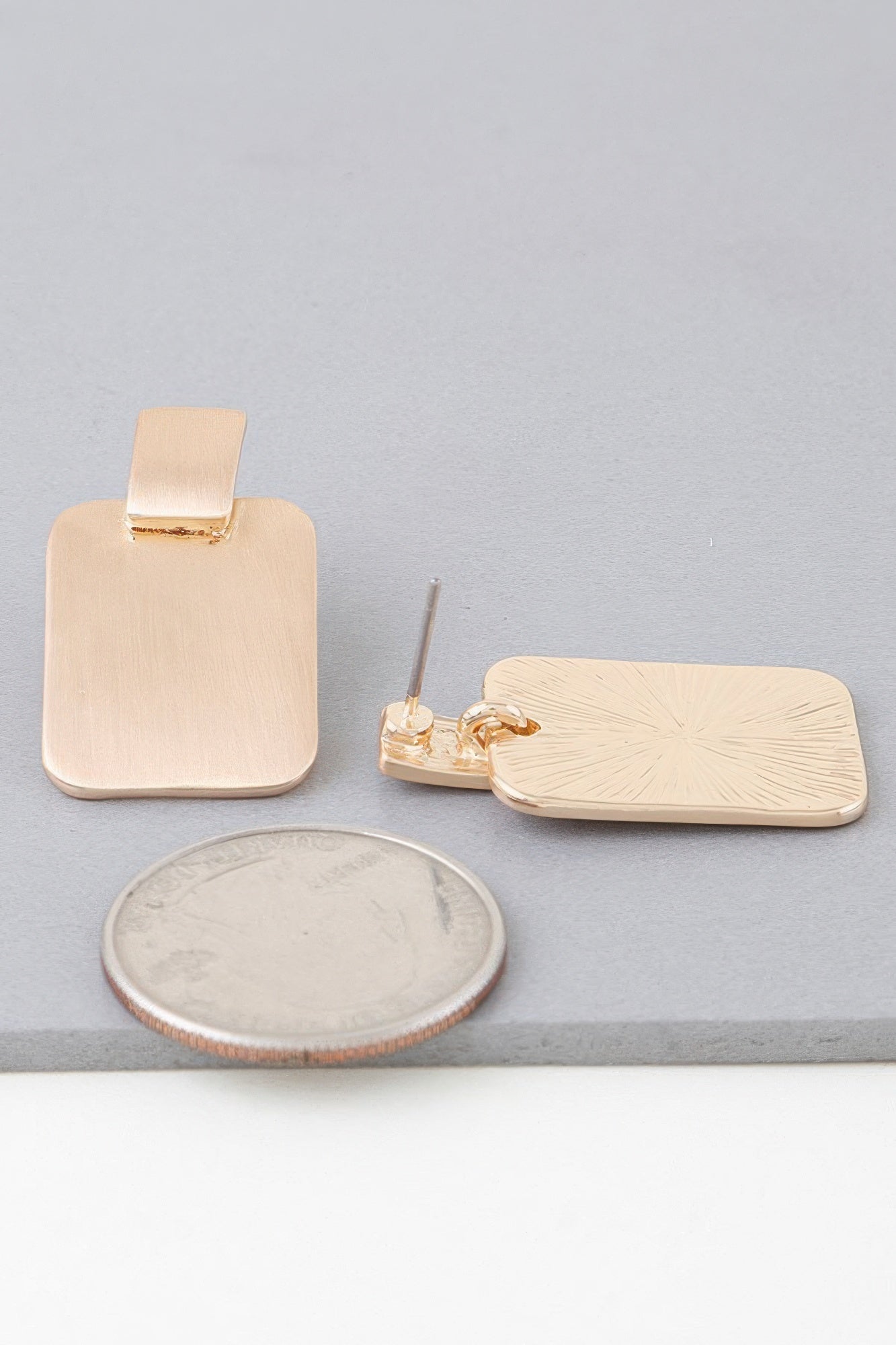 Gold flat geometric earrings with square top, plain rounded-rectangle face, pair