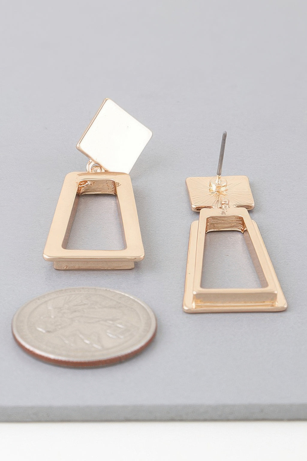 Gold-tone geometric frame drop earrings with square caps and open teardrop frames