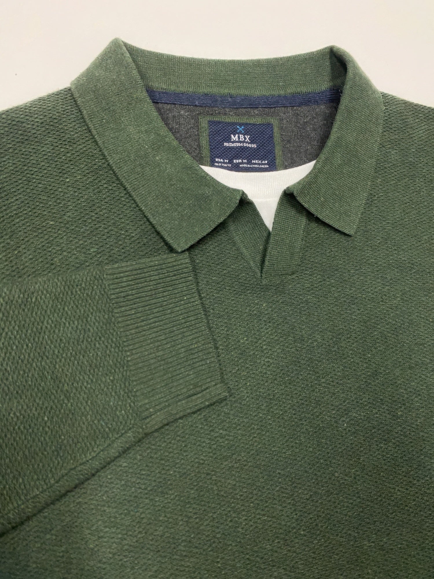 Dark green knit sweater with spread collar and chest pocket detail