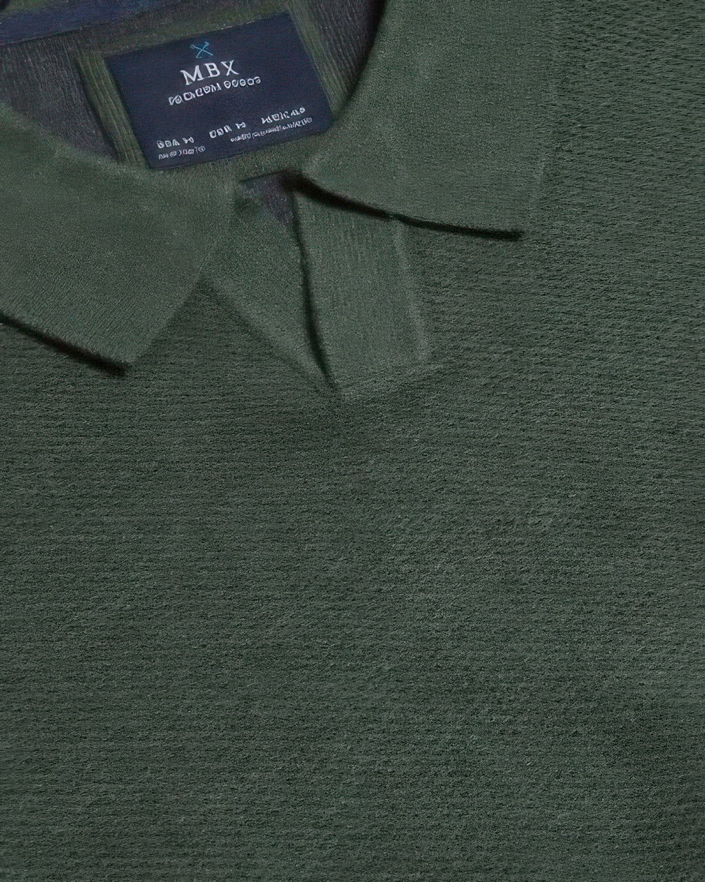 Dark green sweater neckline close-up with inner brand label