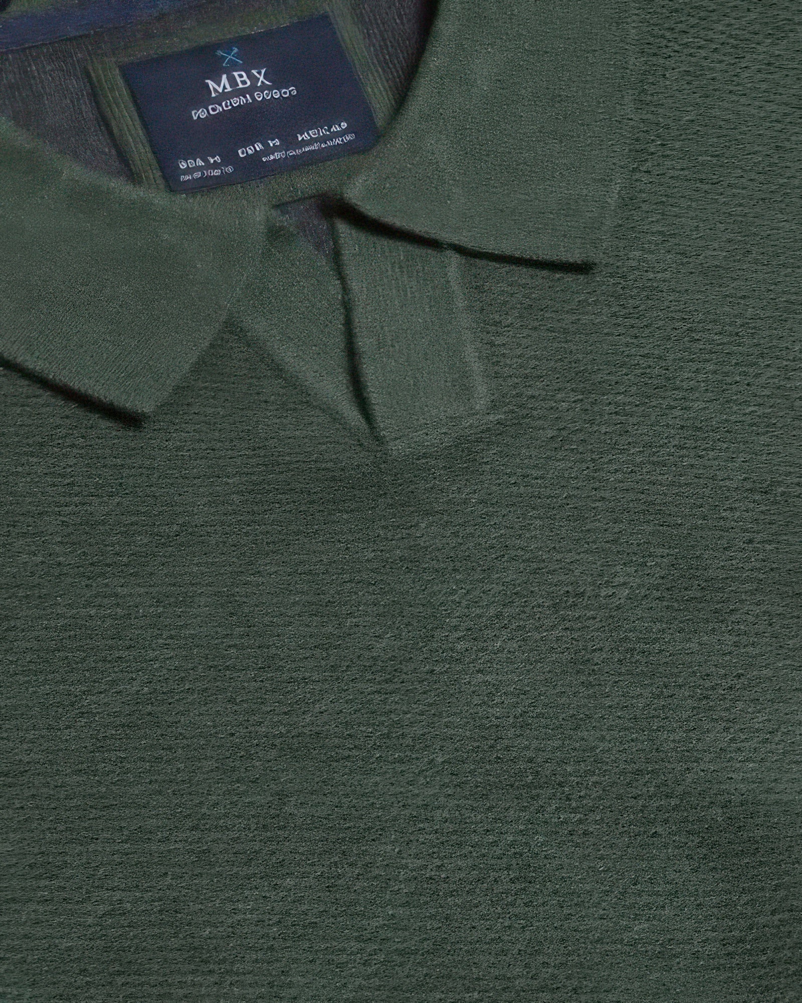 Dark green sweater neckline close-up with inner brand label