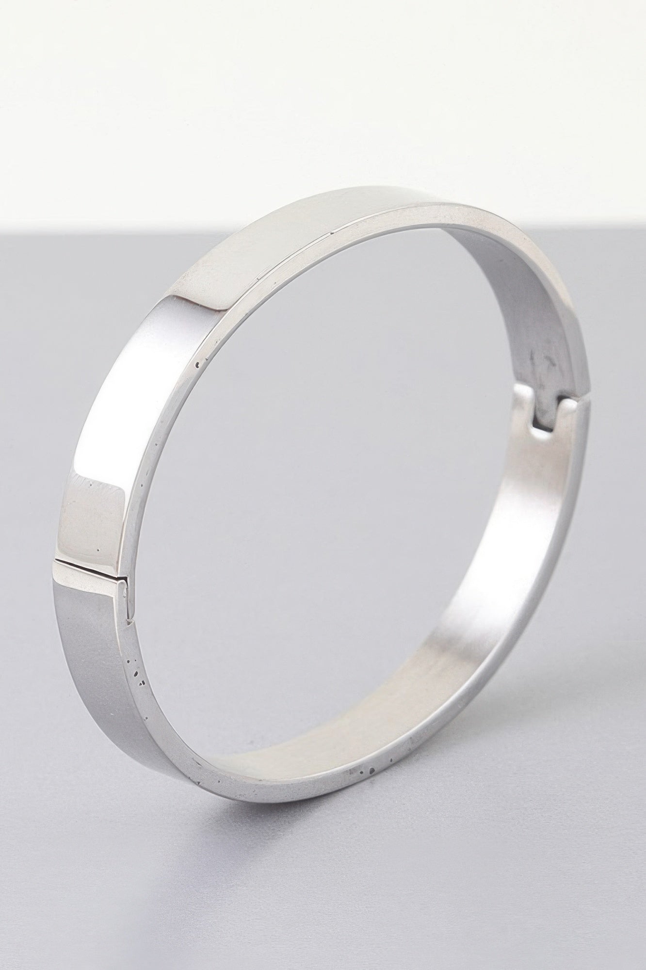 Modern Matte Cuff Bracelet in silver with smooth hinged cuff and rounded opening.