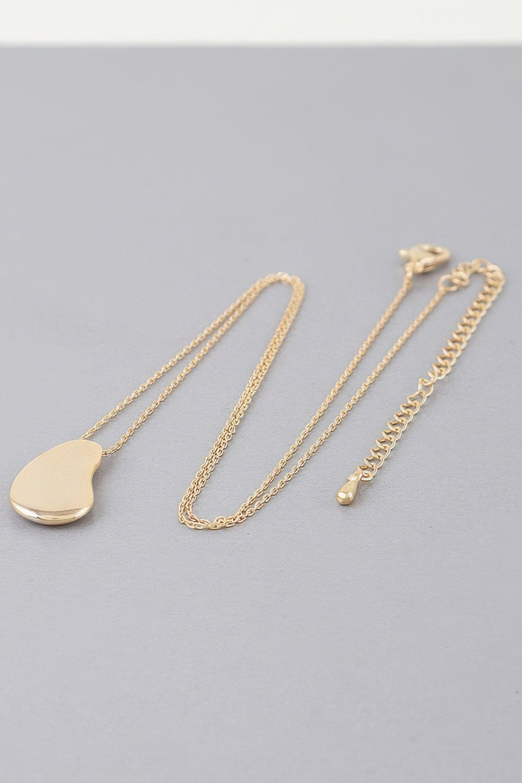 Gold-tone teardrop pendant chain necklace with clasp and linked chain