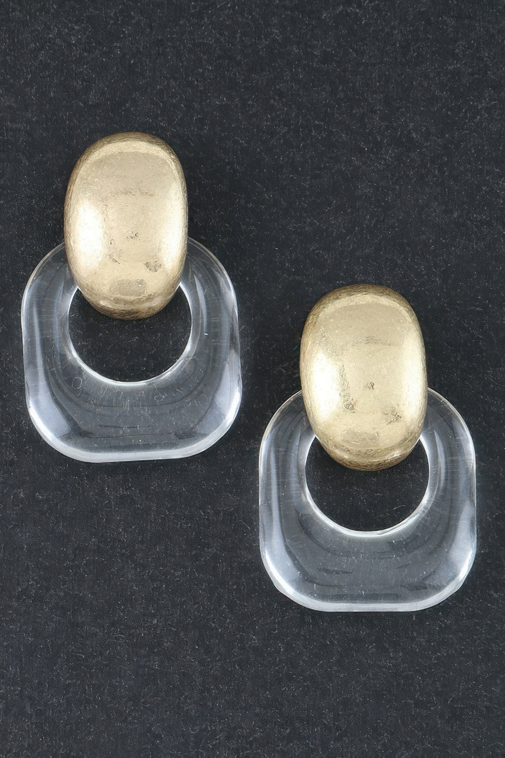 Gold drop earrings with clear curved acrylic hoops and oval gold tops