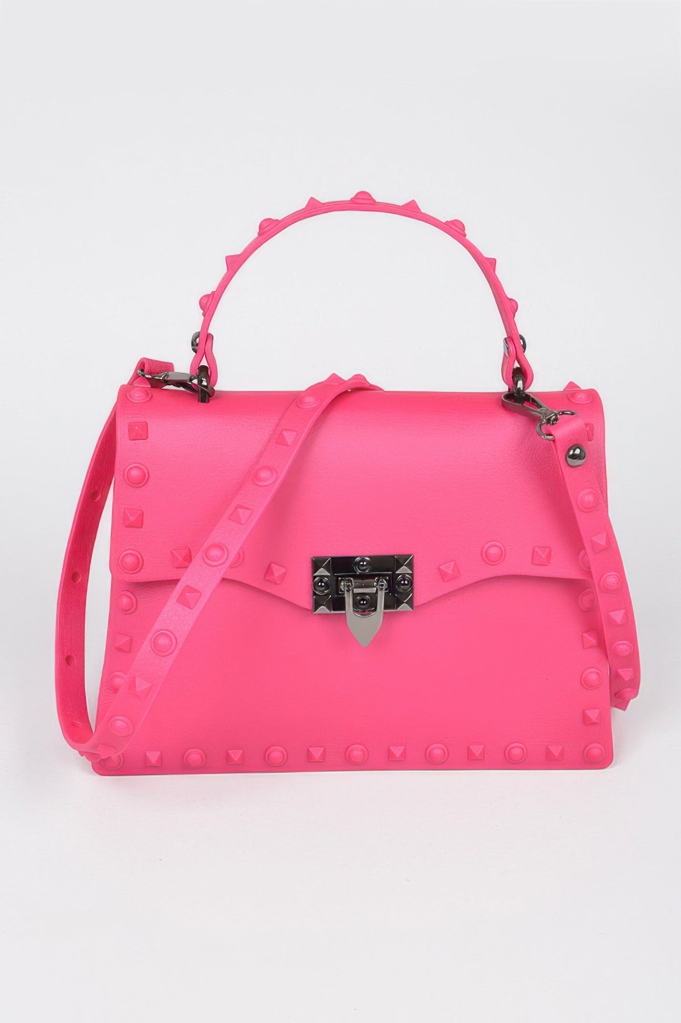 Monotone studded clutch in fuchsia pink with black gem-lock clasp and crossbody strap