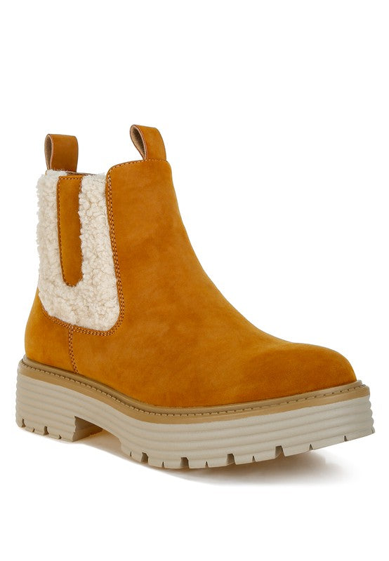Tan chunky ankle boots with cream faux fur trim and pull-on Chelsea sides